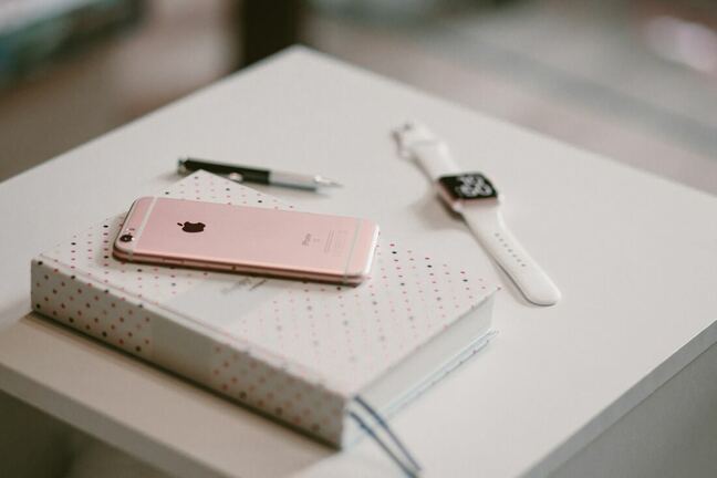 A notebook, iPhone and iWatch to help manage productivity