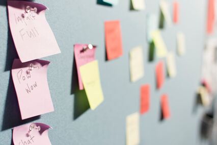Colourful post-it notes on a wall helping a person make good decisions