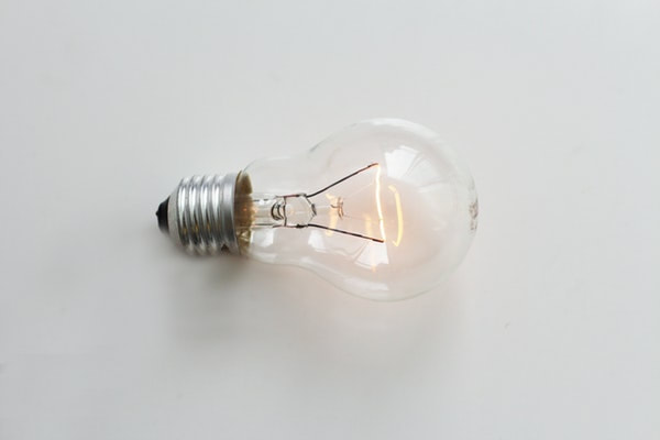 A lightbulb on a white background, illuminating the experience of someone having life coaching